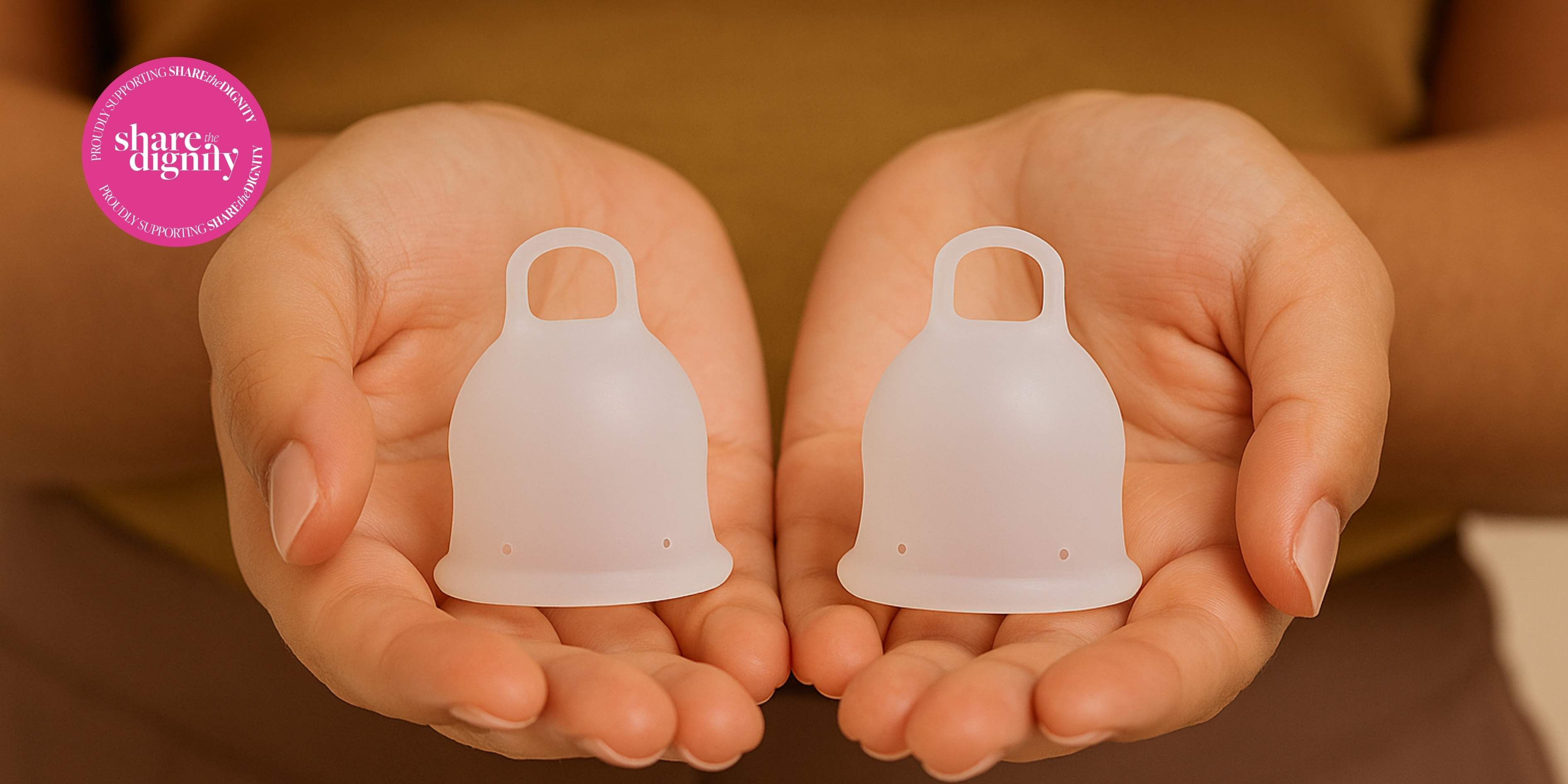 Two silicone menstrual cups held in hands 