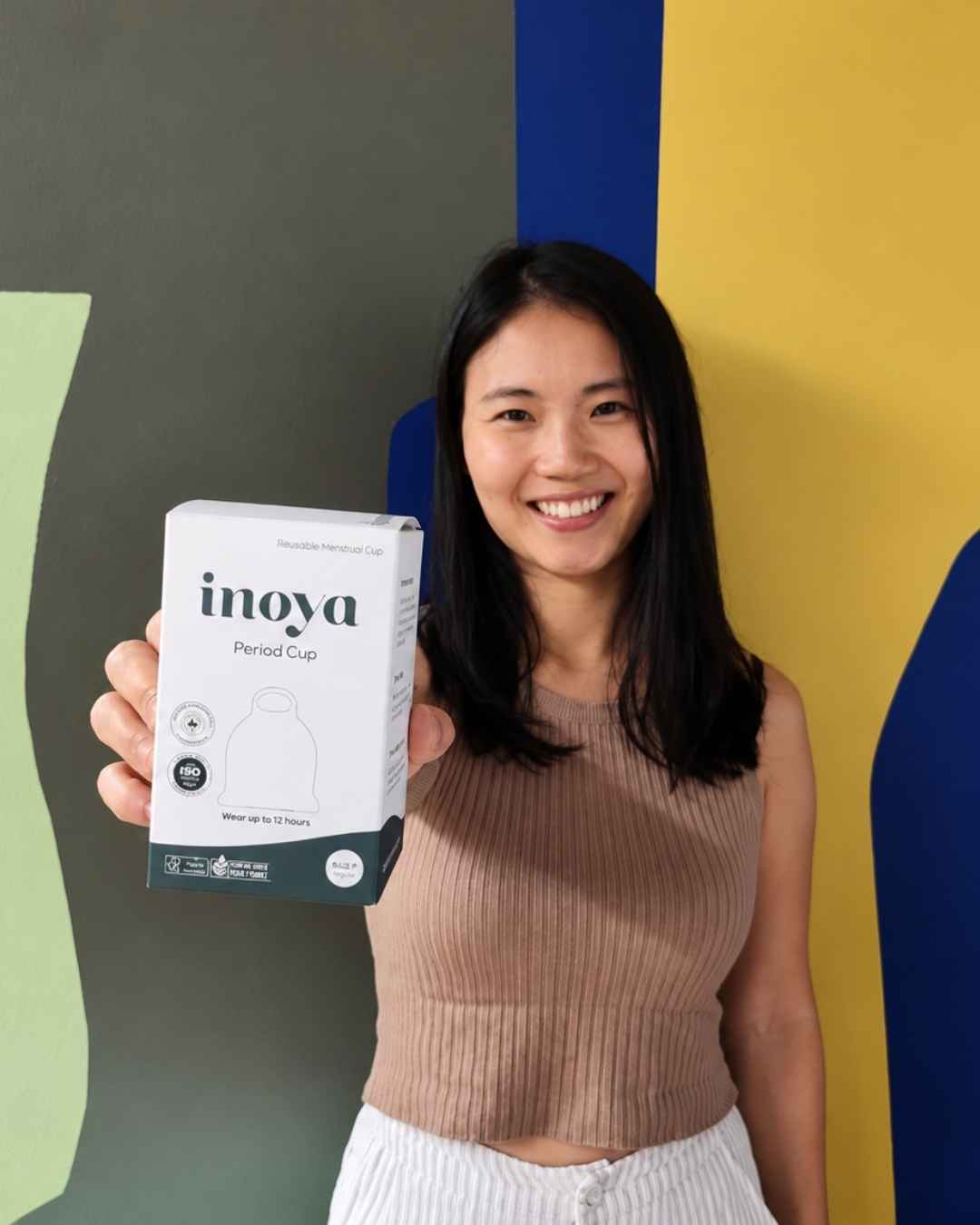 Inoya founder Helena holding a box of Inoya period cup 