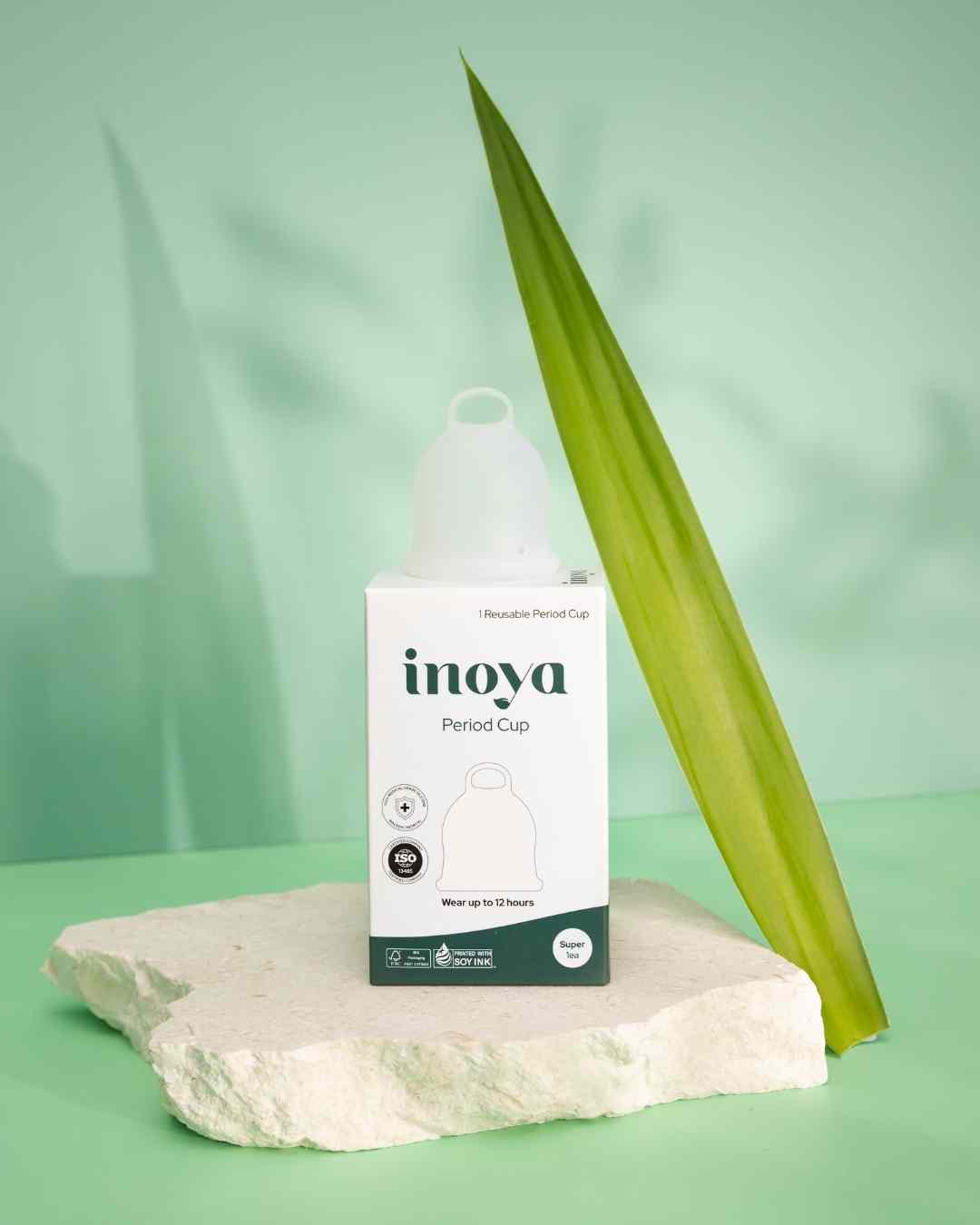 inoya period cup packaging on a green background with a leaf